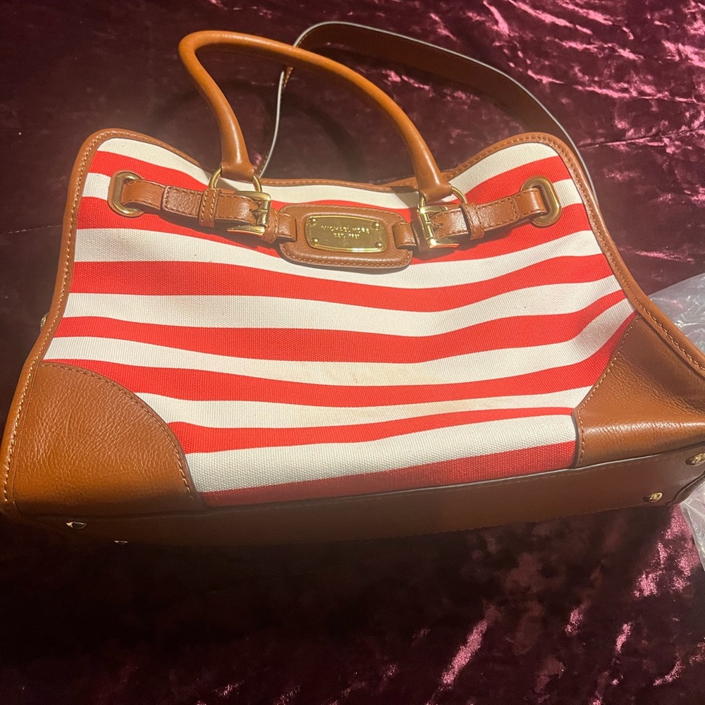 Red and white leather strap gold hardware. Only used a couple of times